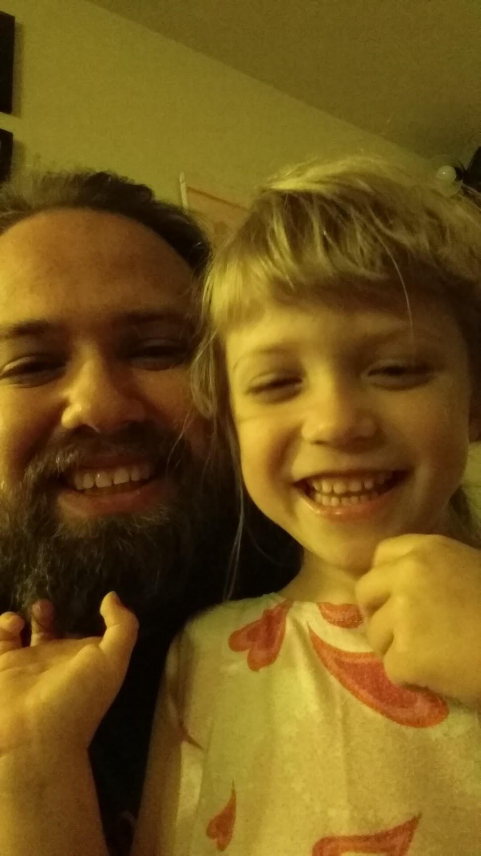 Selfie of two people: a bearded man in his thirties, and a five year old girl. Both are smiling brightly.