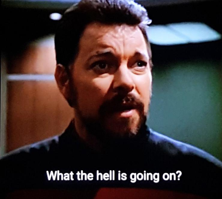 Riker, fully bearded and up close. Closed caption reads, "What the hell is going on?"