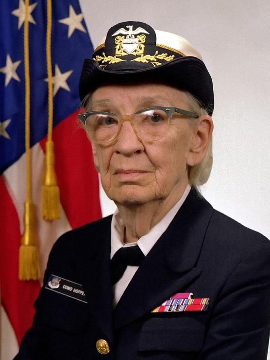 Commodore Grace M. Hopper, USN (covered).

James S. Davis - This image was released by the United States Navy with the ID DN-SC-84-05971 (next).

In the image, she is typically seen wearing her formal cover (hat) as part of her Navy attire. Her uniform signifies her rank and achievements within the U.S. Navy.

This photo captures Hopper during her later career, highlighting her as a trailblazer both in the military and in computer science. Her demeanor in such photos often radiates professionalism, intelligence, and a sense of authority, aligned with her significant contributions to both fields.

The photo's mention of a Navy ID (DN-SC-84-05971) confirms its origin from official Navy archives, further cementing its historical significance.