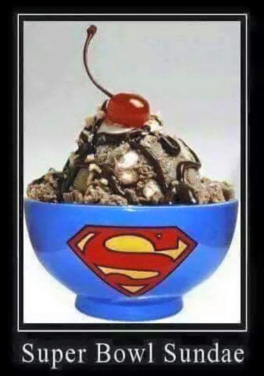 Picture of a large blue bowl full of ice cream, covered in chocolate syrup with a cherry on top. The bowl has a "Superman" logo on the side. The meme reads "Superbowl Sundae."