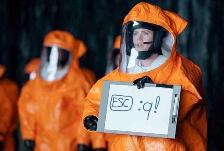 A scene from „Arrival“, but the text on the writing pad reads [ESC] : q !  (the command to exit vi/vim)
