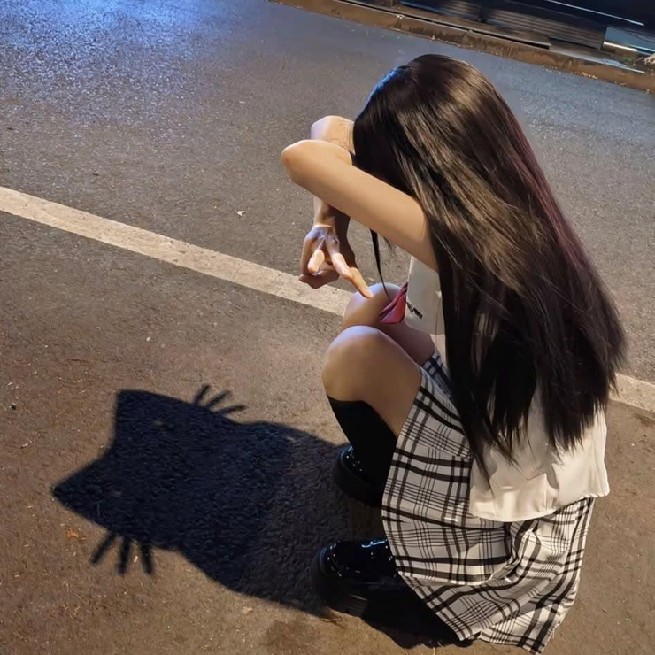 Girl making a cat out of her shadow
