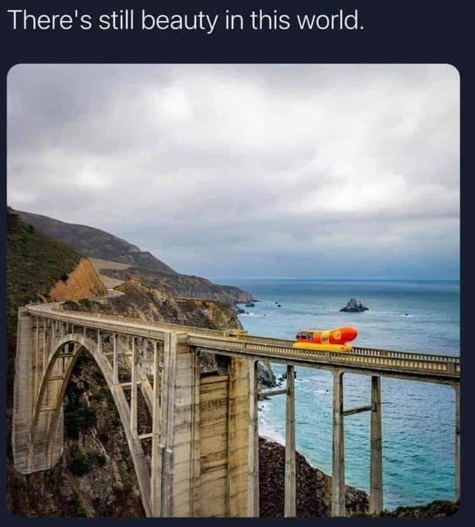 The Oscar-Mayer Weiner Wagon crossing a bridge in a scenic location, captioned "There's still beauty in this world." Lrrr doesn't realize that it's a marketing gimmick and not a real sausage.