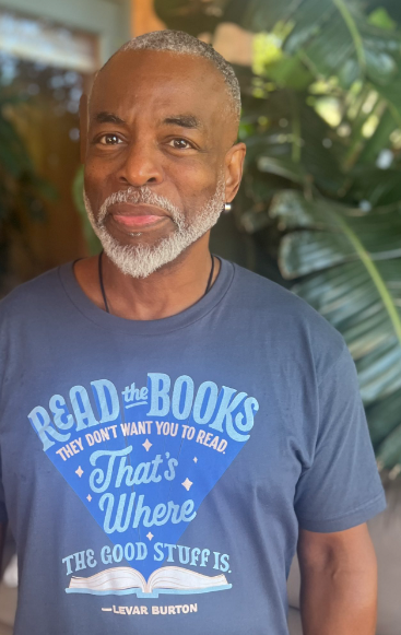 Image of actor and bibliophile LeVar Burton. He's wearing a t-shirt with his quote "Read the books they don't want you to read. That's where the good stuff is."