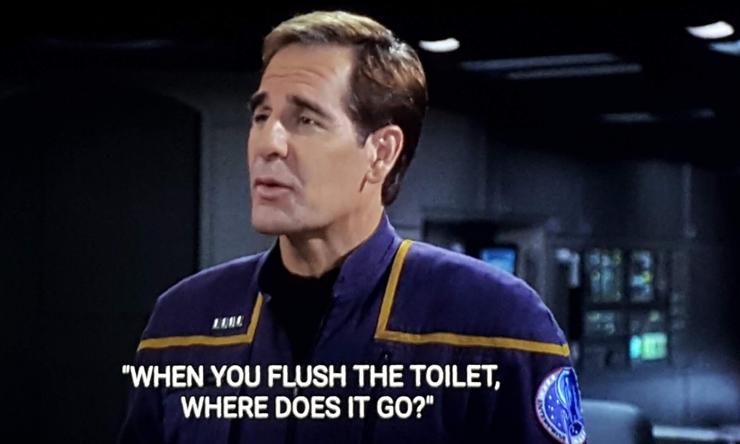 Captain Archer, in uniform, stands on the bridge of the NX Enterprise. Closed caption reads, "When you flush the toilet, where does it go?"